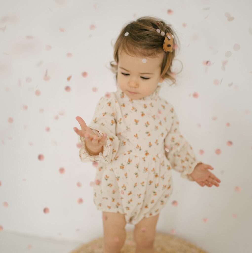 Little baby enjoying confetti during party and celebrations